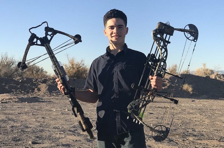 Man Holding Crossbow And Bow