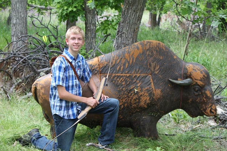 Young Archer Next To 3d Target